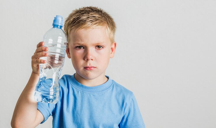 child-holding-bottle