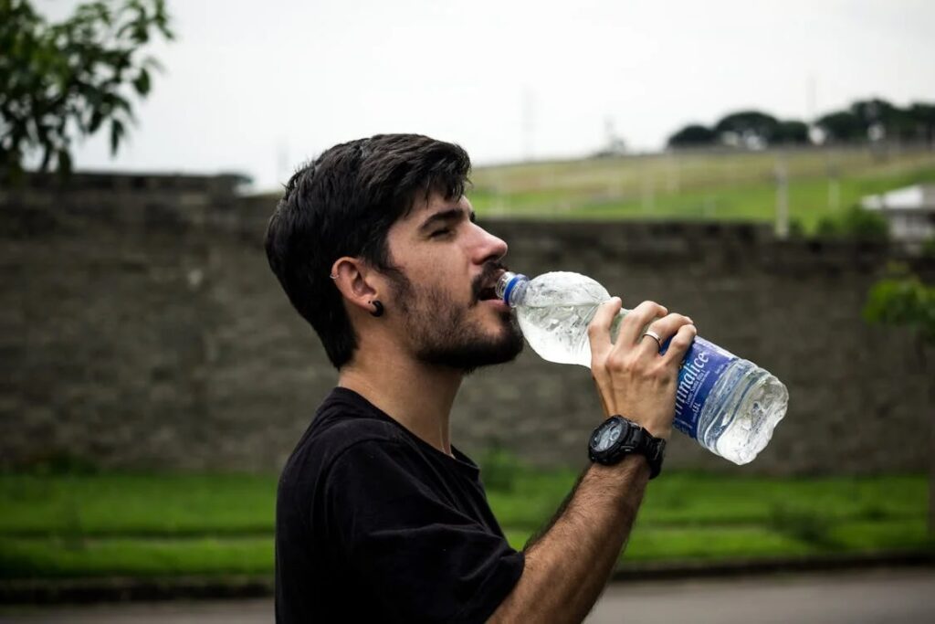 boy drinking water from water bottle