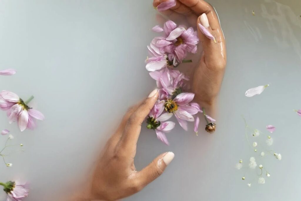 girl hands in flower water