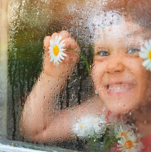 girl kid peeking from the mirror during rainfall